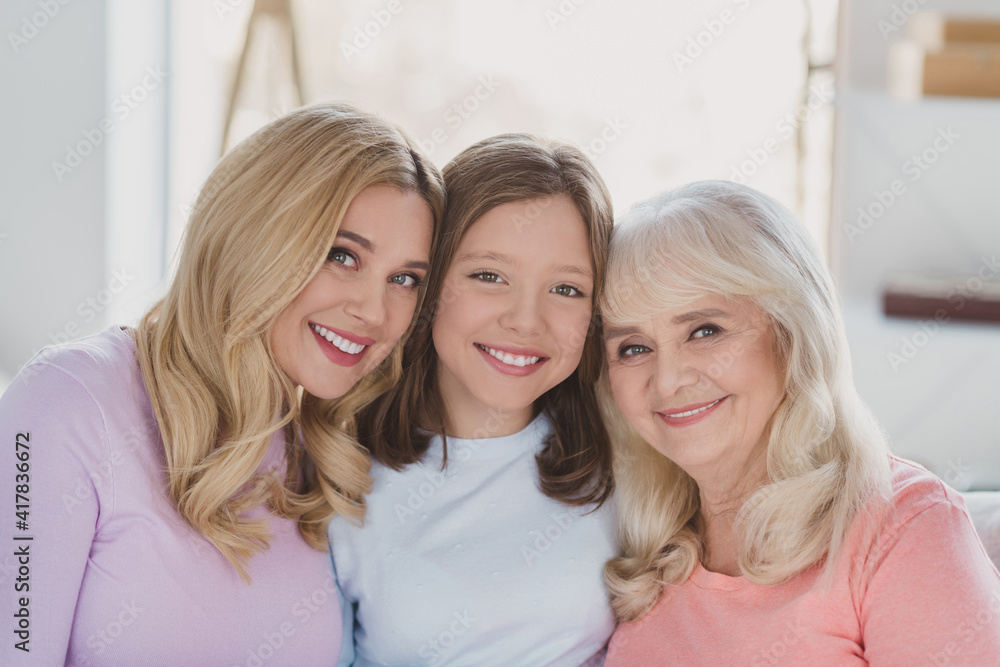 Wall mural Photo of happy nice family generation mother daughter good mood smile indoors inside house apartment