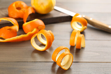 Spiral orange fruit peels on wooden table