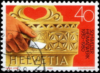 Postage stamp issued in the Switzerland with the image of the Milk cask with woodcarvings. Swiss...