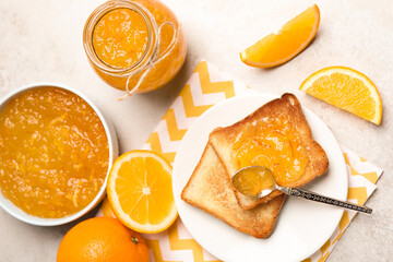 Fototapeta na wymiar Delicious orange marmalade and toasts on light table, flat lay