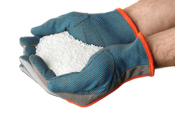 Man holding ammonium nitrate pellets on white background, closeup. Mineral fertilizer