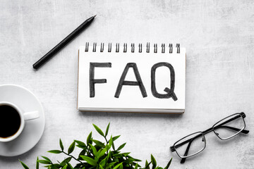 FAQ on office desk. Working with clients concept