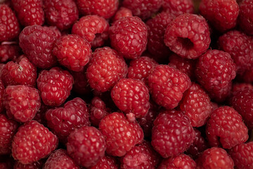 Raspberry background. Fresh large bright appetizing raspberries close up. Top view. Macro photo of raspberry..
