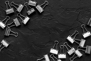 Frame of silver paper binder clips top view. Office supplies pattern
