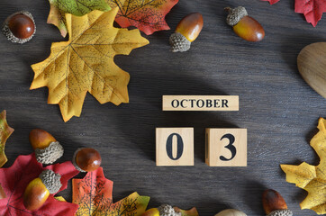October 3, Cover Date design with Calendar cube decorate with maple leaf and Acorn Oak seed for...