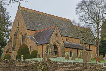 Fototapeta na wymiar Old English rural village church with graveyard cemetary