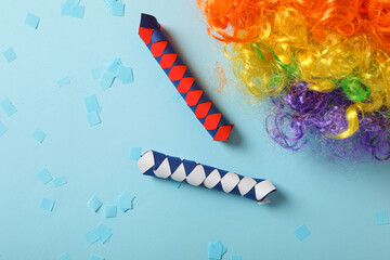 Different clown's accessories on light blue background, flat lay