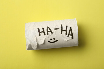 Toilet paper tube on yellow background, top view. April fool's day
