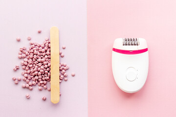 White epilator with pink wax. Epilation concept, removal of unwanted hair. Top view, flat lay