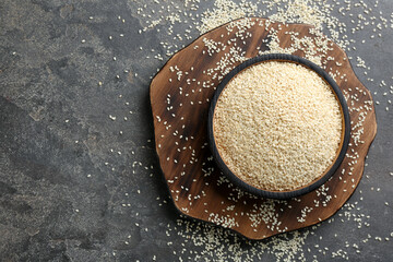 White sesame seeds on grey table, flat lay. Space for text