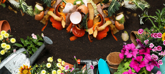 Gardening tools, flowers and organic waste for composting on soil, flat lay. Natural fertilizer