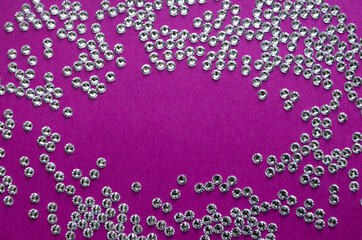 rhinestones on a purple background, top photo. design for text