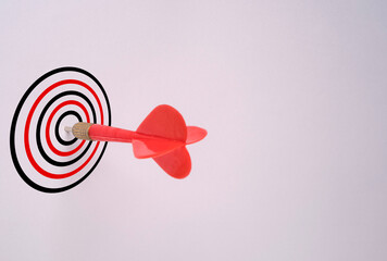 Red dart arrow hit on target board and white background, Business Achievement objective target concept.