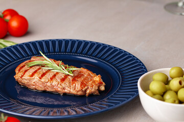 Grilled beef steak served on blue plate