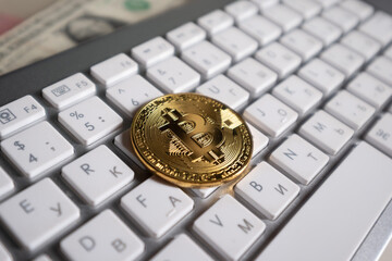 Bitcoin cryptocurrency coin on the background of the computer keyboard - 417845238