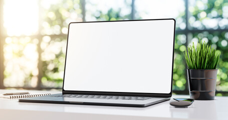 Laptop with blank frameless screen mockup template on the table in industrial office loft interior...