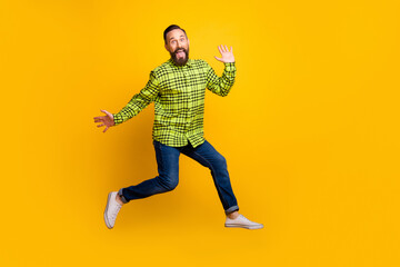 Fototapeta na wymiar Full length photo of mature man happy positive smile have fun jump up excited isolated over yellow color background