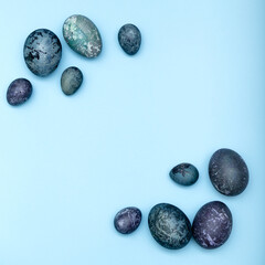 Happy Easter card. Frame with blue cosmic painted easter eggs with copy space for text iisolated on blue background