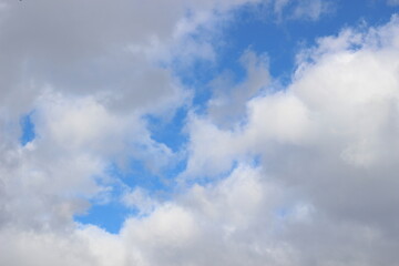 Bright spring blue sky with white  clouds in sun light