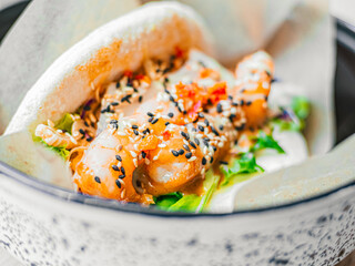 Bao with shrimp. Rice buns with vegetable, seafood filling with sauce, sprinkled with sesame seeds. Fast food in a cafe, restaurant. Macro