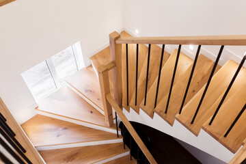 Wood staircase inside contemporary white modern house.