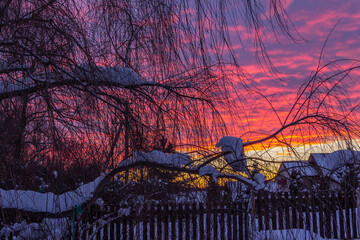 Twilight, country winter scene, colorful dramatic sky during sunset.