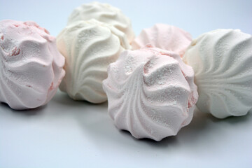 Beautiful and tasty air white pink marshmallow made in Ukraine is located on a white background. 