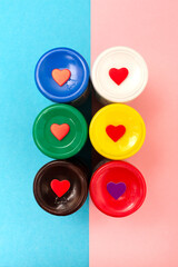 Hearts with acrylic paints on a colored background.