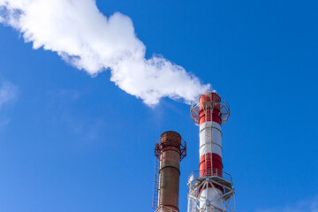 Smoke coming from the chimney of a thermal power plant in St. Petersburg. The use of natural gas in...