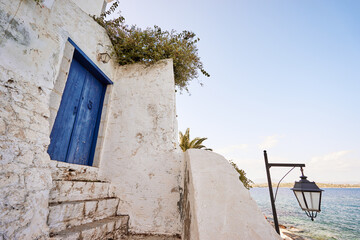 Traditional white houses Aegean architecture. Beautiful cityscape of old Greek town.