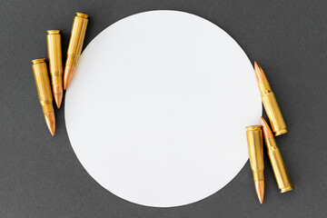 Bullets at corners of white circle on gray paper background. Cartridges 7.62 caliber for...