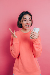 Excited young woman amazed by unbelievable shopping mobile app sale message looking at smartphone, girl winner holding cell phone screaming with joy