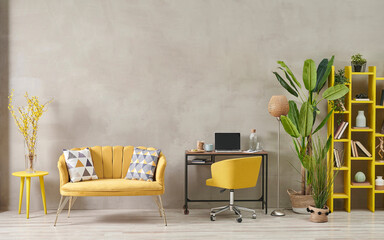 Decorative grey stone wall living room, home interior concept with yellow sofa chair and bookshelf,...