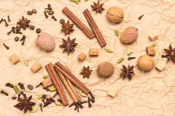 Fototapeta na wymiar Cinnamon sticks, star anise, allspice and cardamom, lychee and walnut