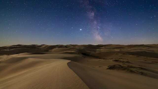 Timelapse of desert under the night starry sky in the Arabian Empty Quarter Desert, UAE. Rub' al Khali