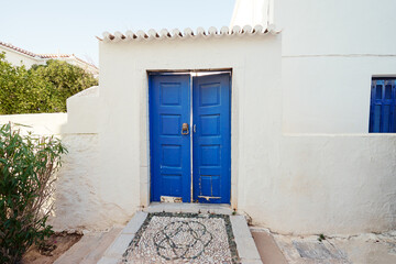Traditional white houses Aegean architecture. Beautiful cityscape of old Greek town.
