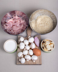 The food ingredients for cooking with rice, chiken and mushrooms