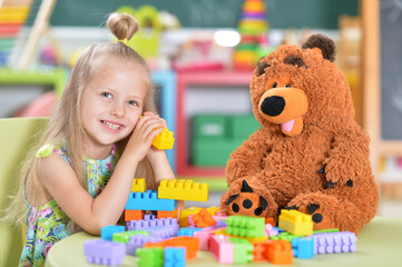 Fototapeta premium girl playing with teddy bear