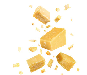 Pieces of delicious parmesan cheese flying on white background