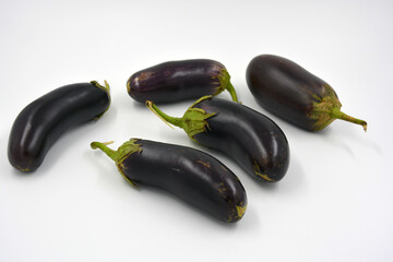 Fresh and healthy vegetables from breast, blue, purple eggplants located on a white background. 