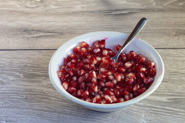 Juicy ripe pomegranate grains. Concept of vegan dessert.