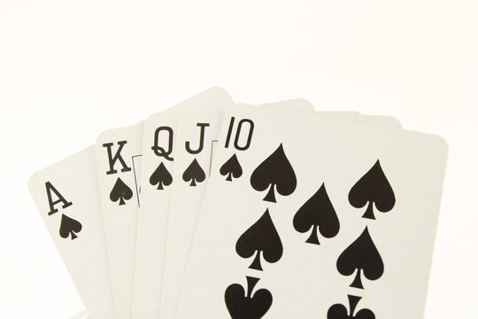 Ace, King, Queen, Jack, Ten of spades. A royal flush poker hand, isolated on white with copy space