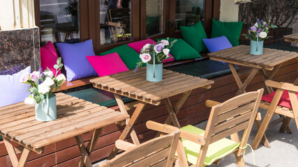 Empty tables in a summer outdoor street cafe