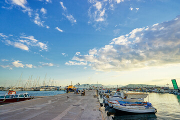 Beautiful colorful sunset on the seashore with boats sea marine.