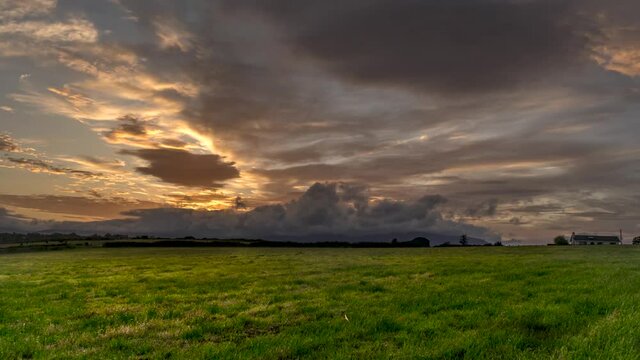 timelapse in green field at sunset with clouds in Bunmahon Ireland