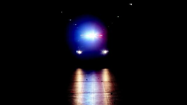 4K of Police car with blue and red lights on parked not driving. On a black background centered in frame.