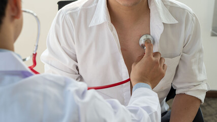 Doctors listen to the patient's heartbeat with a stethoscope, hospital sounds, physical...