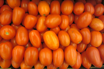 close-up view of some tomatos for sale in a basket in a supermarket