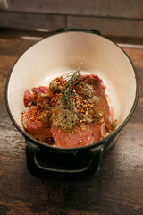 Raw meat with seasoning in a dish
