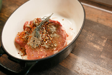 Raw meat with seasoning in a dish